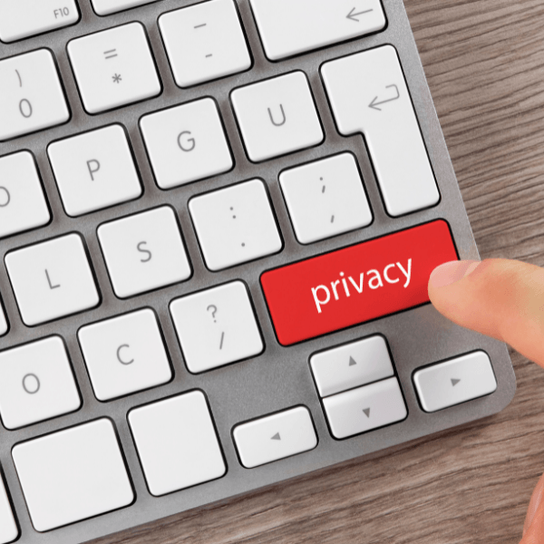 the concept of internet privacy ilustrated by a person's finger hitting a keyboard key with the word "privacy" written on it