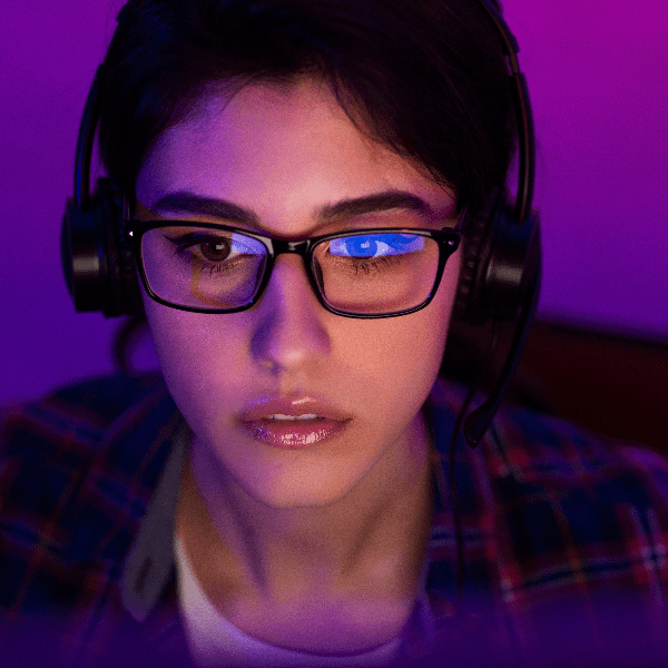 a woman wearing glasses and headphones, looking confused, image illustrates the ethics of cybersecurity